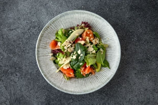 Dietary salad with red fish, pear, avocado and herbs