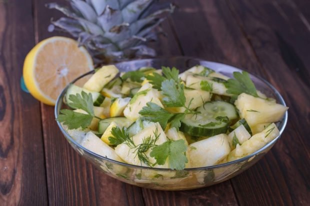 Fresh salad with pineapple, cucumbers and apple