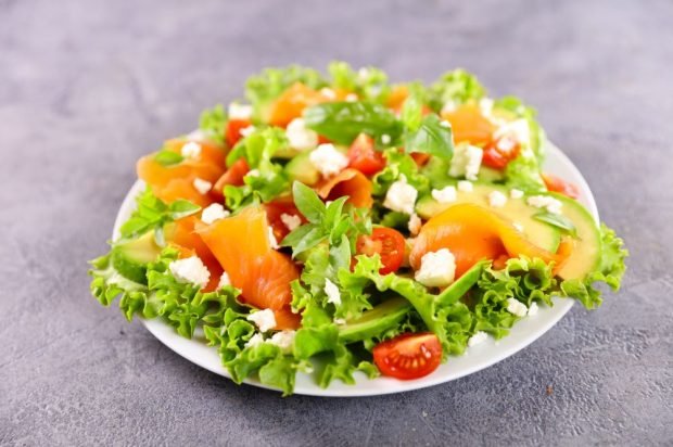 Fresh salad with smoked red fish, avocado and feta cheese