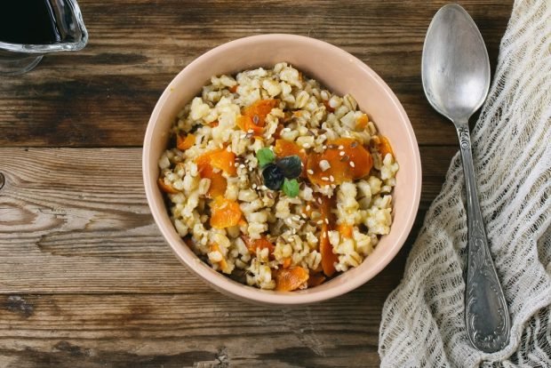 Pearl barley porridge with dried fruits and honey